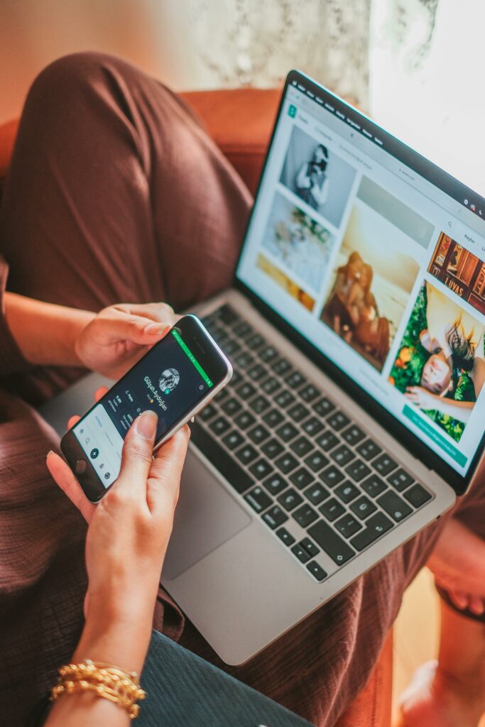 A Person with a Smartphone and a Laptop