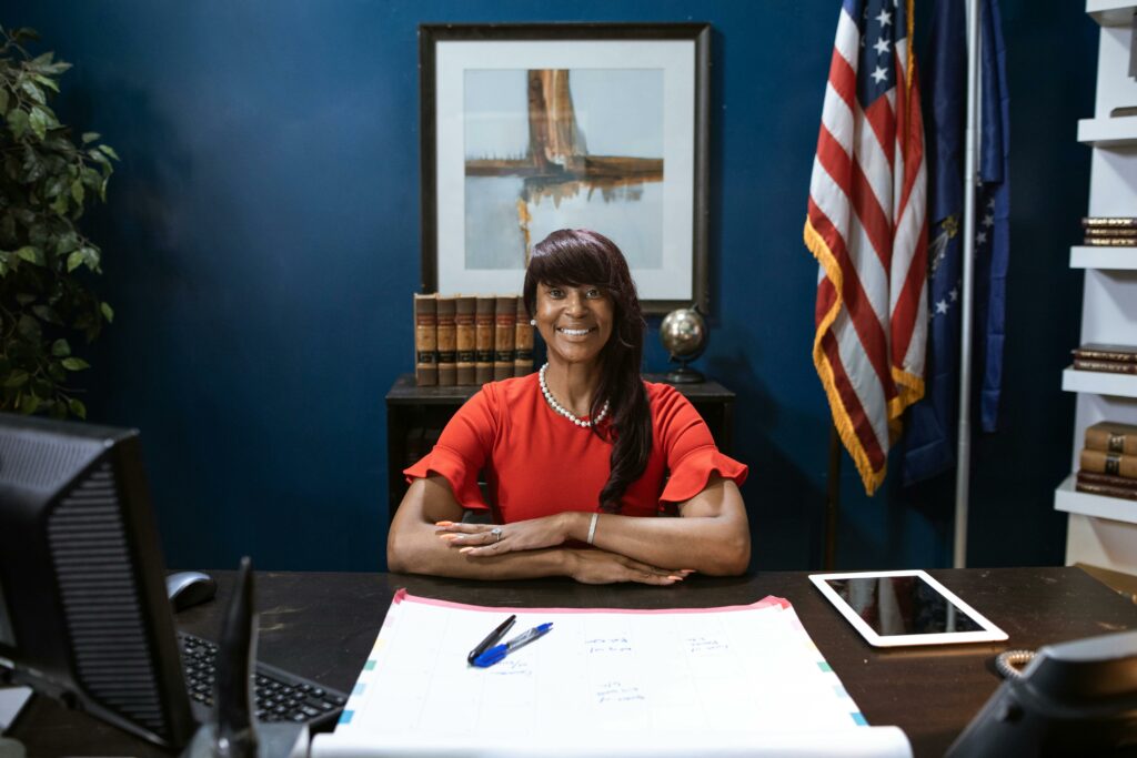 A Woman in Red Shirt Sitting on a Chair